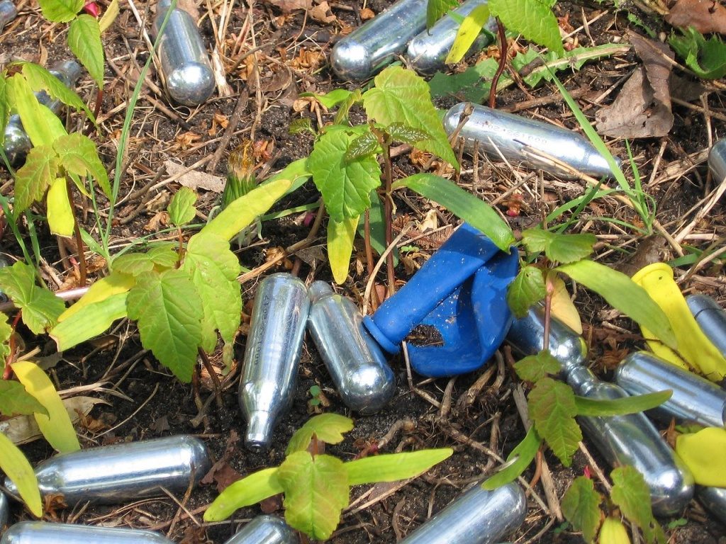 Nitrous Oxide canisters lying on ground